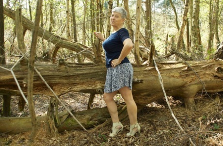 The spherical breasts of dashing old grandma Savana are showcased in the woods.
