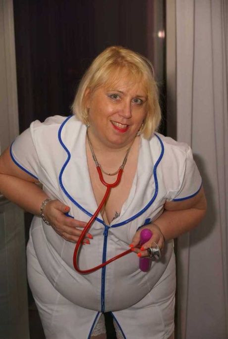 Obese blonde nurse Lexie Cummings uses a vibrator to stimulate her while she masturbates on a sofa.