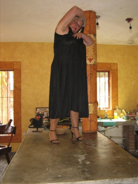 A Girdle Goddess on Fat Oma's belly, strips herself to tan pantyhose and performs the ritual on an island in the kitchen.