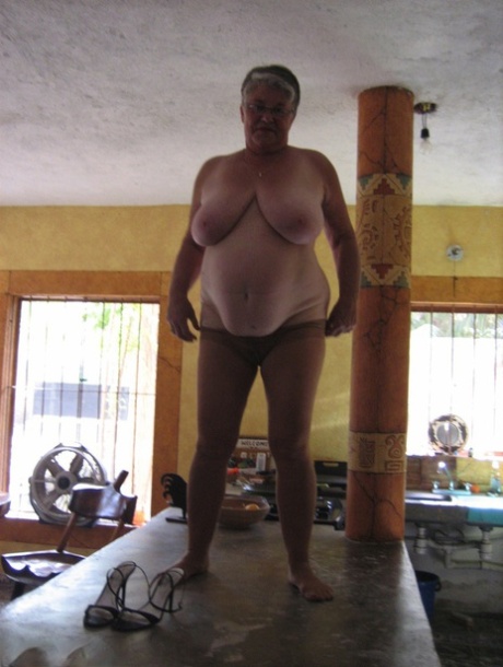 Using her fat oma Girdle Goddess, she strips naked and puts on some tan panties on an island in the kitchen.