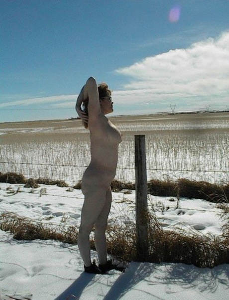 Illuminating: Misha MILF, a mature amateur player, lies naked on a snowy terrain during his winter break.