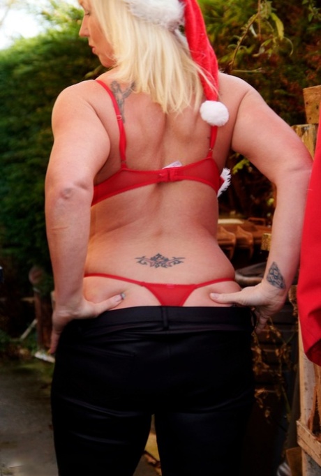 Melody, a busty blonde amateur, displays her pierced nipples over the Christmas holiday.