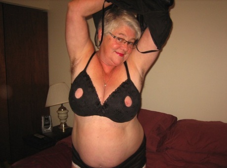 Following the act of stripping, the old lad (also known as the Girdle Goddess) disrobes and sticks a toy into her wet pussy.