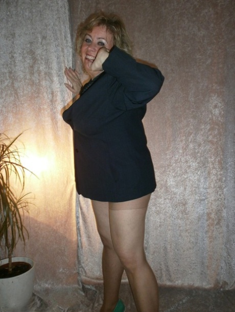 Naked bra and pantyhose are used by the amateur, Blonde Caro, who removes a blazer to model in the nude.