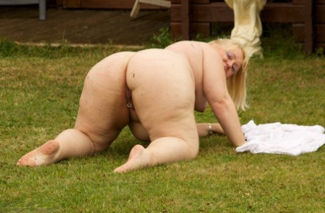 Obese: Mature blonde Lexie Cummingses expose her fat body on the back lawn.