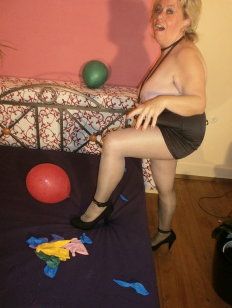 While a grown woman, Caro displays her breasts in pantyhose and hangout with balloon hanging from her bed.