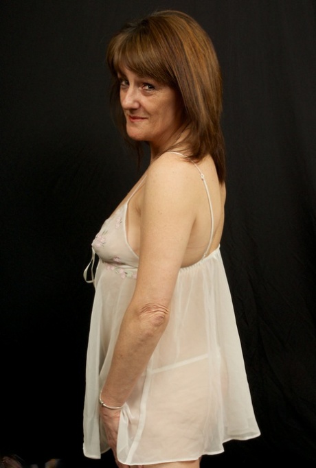 In her full-figured buttocks, the older Pandora sheds sheer white lingerie to spread her exposed backside.