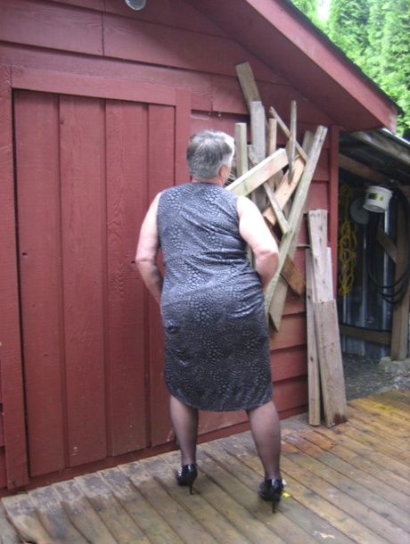 Fat Oma Girdle Goddess Unleashes Her Large Boobs Next To A Boarded-up Building