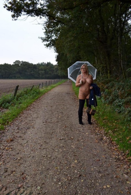 Despite her big-haired body, Chrissy is seen walking naked in the rain with glasses on.