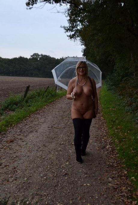 In the rain, a naked and overweight Chrissy with big tongue, full of glasses, displays her fat buttocks.