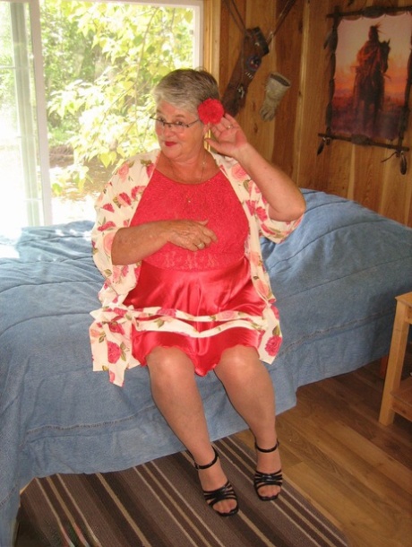 The short-haired granny Girdle Goddess stripped down to her stockings and high heels.