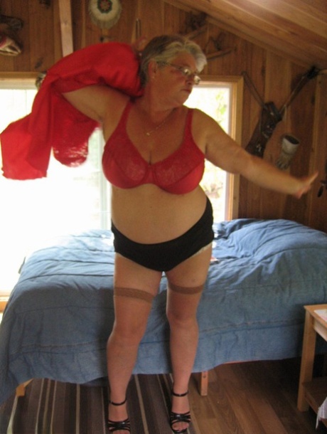 Despite her short hair, the granny Girdle Goddess removes all her clothing from her stockings and high heels.