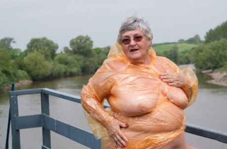 An opaque raincoat is being removed by Grandma Libby, an obese British amateur, through the air.