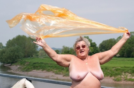 An obsessive British amateur named Grandma Libby removes a raincoat that is transparent.