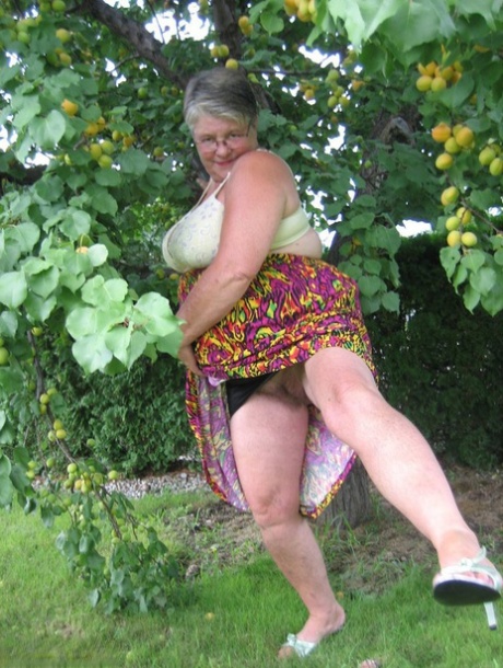 Fat Granny Girdle Goddess Exposes Her Large Tits Under A Fruit Bearing Tree