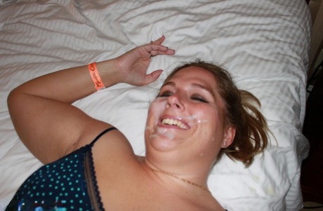 On a bed, a fat and amateur Gangbangmomma wears cum on her face as a sign of pleasure after sexual intercourse.
