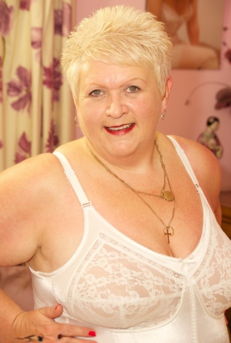 Older BBW Dirty Doctor loses his tits from the side of her bed while sporting short blonde hair.