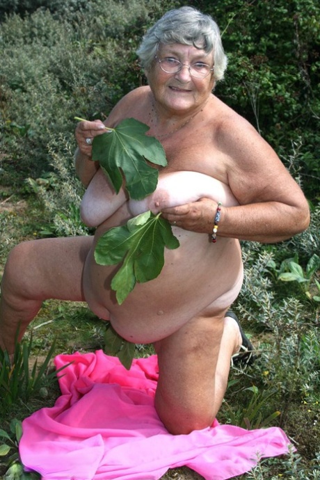 Exposed British woman Grandma Libby is seen naked on a towel while being hit by dirt.