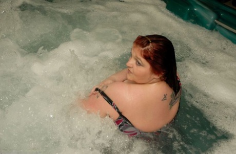 Widow AK, who is an obsessive redhead and naked, takes a dip in a hot tub.
