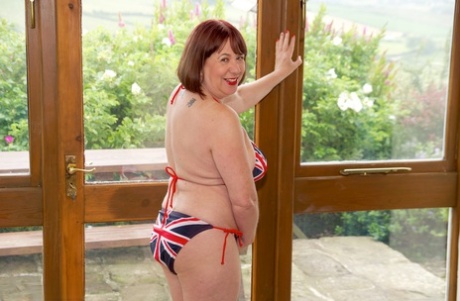 Older UK Redhead Speedy Bee Doffs A Union Jack Bikini To Get Naked