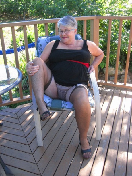 Before stripping off in nylons, the Girdle Goddess, a novice grandmother, smokes.