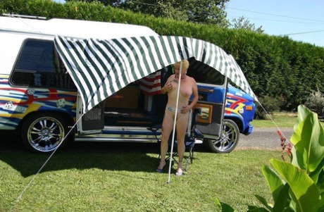 Her big tits and pussy are revealed by Mary Bitch, who is now mature blonde, outside a B class camper van.