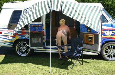 The big tits and pussy of Mary Bitch, who is now mature and blonde, are displayed outside a B class camper van.