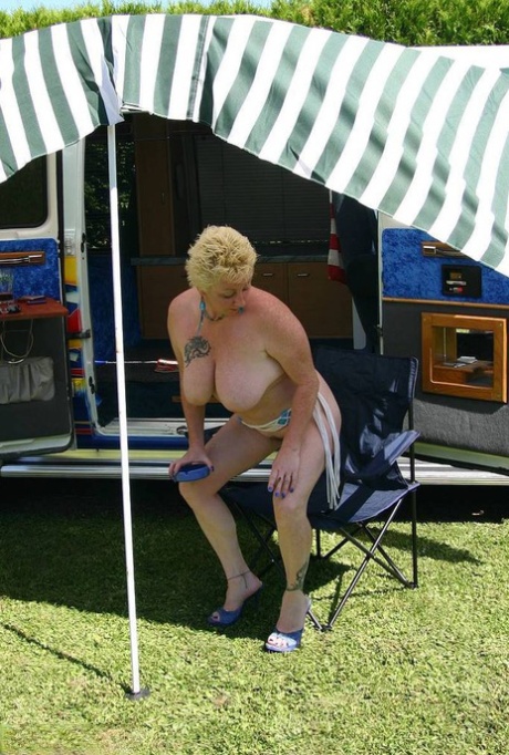 Outside a B class camper van, Mary Bitch is photographed with her big tits and pussy, while still being young and blonde.