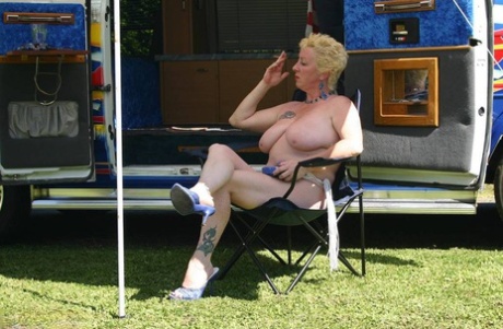 During her tenure as an adult, Mary Bitch exposes her big tits and pussy outside a camper van.