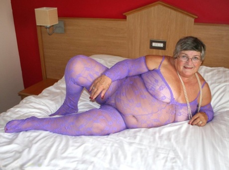In the crotchless bodystocking, Grandma Libby (the British fat lady) masturbates on a bed.