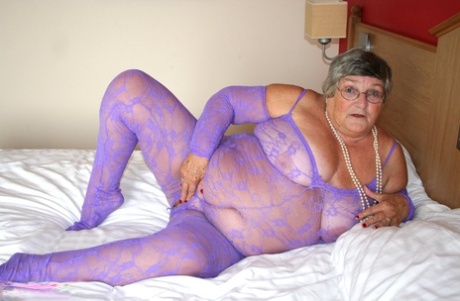 In a bodystocking made entirely without legs, Grandma Libby (a British fat lady) masturbate on the bed.