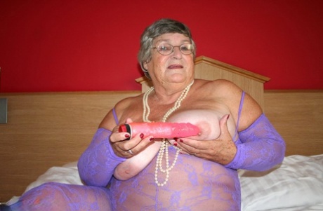 The British fat lady Grandma Libby is seen in her own bodystocking, which she wears not to show any of its legs but still masturbates on the bed.