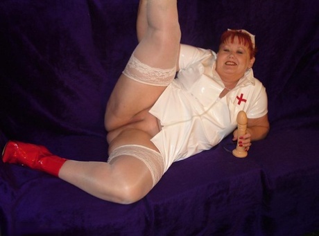 In the act of dildo play, Valgasmic Exposed exposes herself as a mature redheaded nurse.