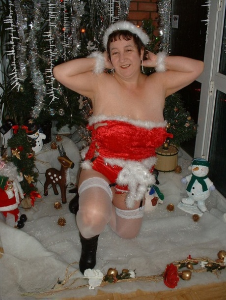 In a festive moment, an adult young girl named Kinky Carol displays her breasts during a Christmas scene.