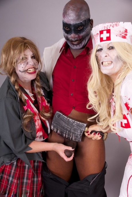 Some older members of the amateur group tug on a black man's penis while wearing cosplay clothing.