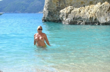 Chrissy, a massively plump and fully clothed adult female, swims and lounges on the beach naked.