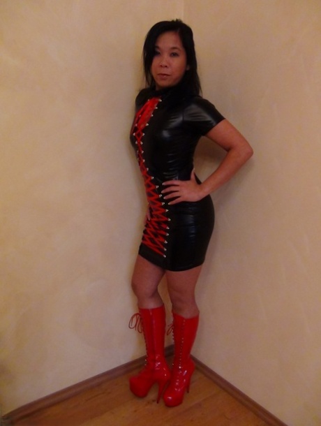The hot latex and high-heeled boots on this gorgeous Asian lady are adorned with sexy upskirts.