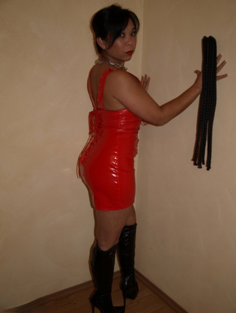 A stunning Asian woman donning hot latex and high-heeled boots exudes femininity, paired with sexy upsets.