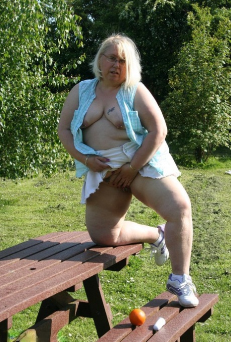 On a picnic table, an orange is placed in the middle of the group by Lexie Cummings, who is an elderly woman with no memory of being overweight.