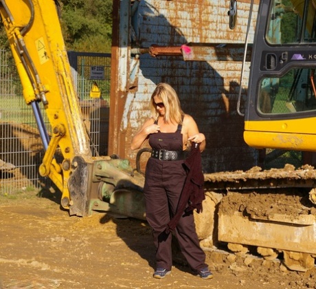 Naked beauty: The blonde amateur nude Chrissy exposes herself in shades while wearing heavy equipment.