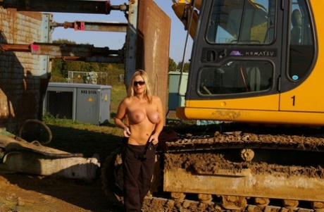 Blonde amateur: Nude Chrissy bares her hands behind heavy equipment and wears makeup.