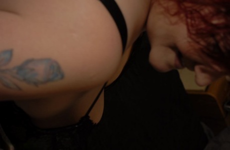 The bed of a Redheaded BBW Black Widow, known as AK, is where I can see her in a black bra and panty.