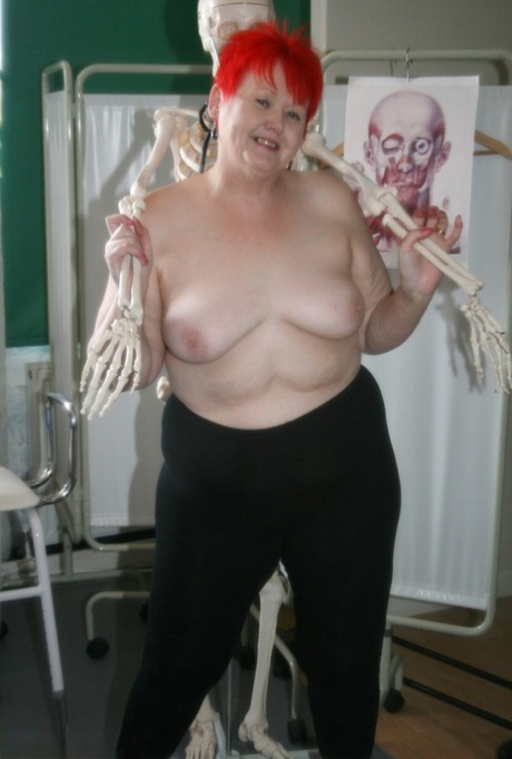 The slutty, white nurse in stockings is cuddled by a skeleton.
