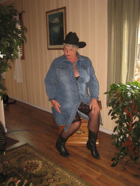 Fat Oma Girdle Goddess is seen wearing a cowgirl hat and boots while stripping naked.