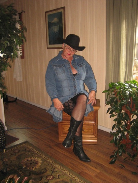 A cowgirl hat and boots are worn by Fat Oma Girdle Goddess as she strips naked.