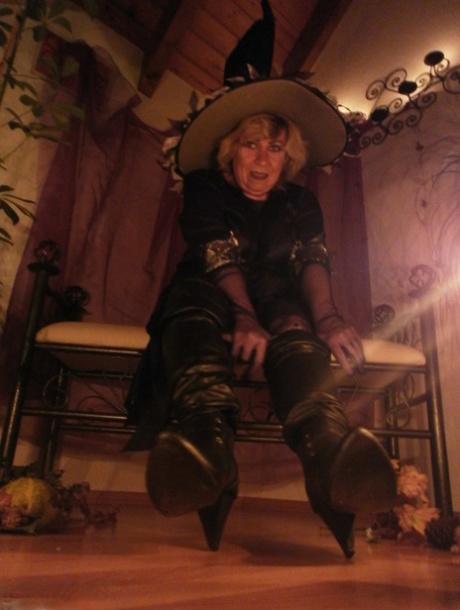 Dressed in black boots and panty, the slutty-looking Caro looks very alluring as a mature witch.