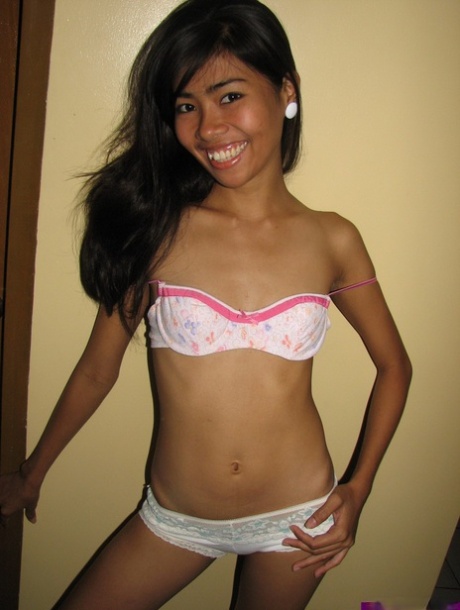 A slim Asian 18-year-old girl displays her hairless but untamed vagina after a striptease.