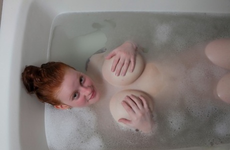 Pale Redhead Kaycee Barnes Displays Her Large Boobs And Butt During A Bath