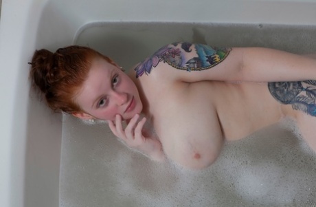 Pale Redhead Kaycee Barnes Displays Her Large Boobs And Butt During A Bath