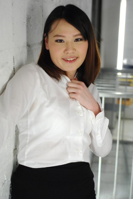 Asian fashion icon Aki Sasahara wears a white top and black skirt.